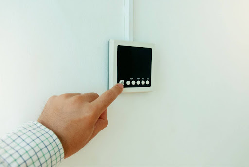 Close-up Man hand turning on-off air conditioner panel